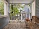 Covered porch with wood bench and side table at 101 S Downing St # 8, Denver, CO 80209