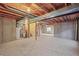 Unfinished basement offers vast potential and features exposed beams and concrete walls at 11005 Cannonade Dr, Parker, CO 80138