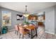 Dining room with wooden table, pendant lighting, and view into the bright kitchen at 11005 Cannonade Dr, Parker, CO 80138