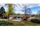 Beautiful aerial view of a home with mature trees and distant mountain views at 8895 Morton Rd, Niwot, CO 80503