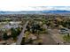 Panoramic aerial view showcasing the neighborhood, mature trees, and mountain range in the background at 8895 Morton Rd, Niwot, CO 80503