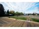 View from the spacious backyard deck showing lawn, mature trees, and play area at 8895 Morton Rd, Niwot, CO 80503