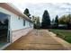 A spacious wooden deck extends along the back of this charming home at 8895 Morton Rd, Niwot, CO 80503