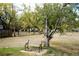 A wooden bench sits in the backyard under a mature tree at 8895 Morton Rd, Niwot, CO 80503