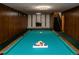 Finished basement featuring a pool table with a fireplace and staircase in the background at 8895 Morton Rd, Niwot, CO 80503