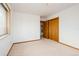 Bright bedroom with beige carpet and closet space, natural light from a large window at 8895 Morton Rd, Niwot, CO 80503