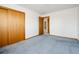 Carpeted bedroom with closet and doorway to connecting spaces at 8895 Morton Rd, Niwot, CO 80503