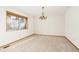 Dining room with neutral carpet, chandelier and natural light from the large window at 8895 Morton Rd, Niwot, CO 80503