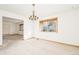 Dining room with neutral carpet, chandelier, and natural light from the window at 8895 Morton Rd, Niwot, CO 80503