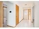 Bright foyer with white tile flooring, white walls, and natural wood doors at 8895 Morton Rd, Niwot, CO 80503