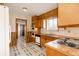Retro kitchen featuring wood cabinets, vintage appliances, and unique tile flooring at 8895 Morton Rd, Niwot, CO 80503