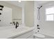 Bright bathroom features white subway tile, black hardware, and a combination shower and tub at 7870 W 43Rd Pl, Wheat Ridge, CO 80033