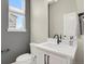 Stylish half bathroom features a white vanity and modern fixtures with natural light at 7870 W 43Rd Pl, Wheat Ridge, CO 80033