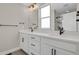 Bright bathroom with double vanity, quartz countertops, modern fixtures, and large mirrors at 7870 W 43Rd Pl, Wheat Ridge, CO 80033