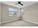 Neutral bedroom featuring a ceiling fan and two windows with a view of the neighborhood at 7870 W 43Rd Pl, Wheat Ridge, CO 80033