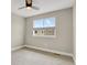 Neutral bedroom featuring a ceiling fan and a window with a view of the neighborhood at 7870 W 43Rd Pl, Wheat Ridge, CO 80033