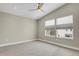 Neutral bedroom featuring a ceiling fan and two windows with a view of the neighborhood at 7870 W 43Rd Pl, Wheat Ridge, CO 80033