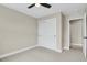 Neutral bedroom featuring a ceiling fan, closet, and doorway to another room at 7870 W 43Rd Pl, Wheat Ridge, CO 80033