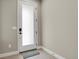 Clean, modern entryway featuring a white door with frosted glass panel and tiled flooring at 7870 W 43Rd Pl, Wheat Ridge, CO 80033