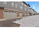 A row of modern townhomes featuring attached garages and well-maintained landscaping at 7870 W 43Rd Pl, Wheat Ridge, CO 80033