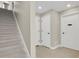 Hallway with carpeted stairs, a neutral color scheme, and closet and office doors at 7870 W 43Rd Pl, Wheat Ridge, CO 80033