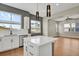 Open concept kitchen with stainless steel appliances, kitchen island and access to an adjoining living room at 7870 W 43Rd Pl, Wheat Ridge, CO 80033