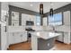 Modern kitchen with stainless steel appliances, quartz countertops, and stylish pendant lighting at 7870 W 43Rd Pl, Wheat Ridge, CO 80033