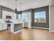 Open-concept kitchen with stainless steel appliances, island, and large windows for natural light at 7870 W 43Rd Pl, Wheat Ridge, CO 80033