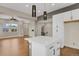 Bright kitchen with stainless appliances, island with seating, and open access to the living room at 7870 W 43Rd Pl, Wheat Ridge, CO 80033