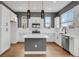 Bright kitchen features stainless steel appliances, central island, and hardwood floors at 7870 W 43Rd Pl, Wheat Ridge, CO 80033