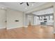 Open-concept living room with hardwood floors leading into a modern kitchen with white cabinets at 7870 W 43Rd Pl, Wheat Ridge, CO 80033