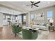 Bright, open-concept living room with modern decor and hardwood floors connected to the modern kitchen and a ceiling fan at 7870 W 43Rd Pl, Wheat Ridge, CO 80033