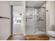 Modern bathroom featuring a frameless glass shower, wood-look flooring and updated fixtures at 18438 E Berry Dr, Centennial, CO 80015