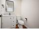 Updated half bathroom with modern fixtures, marble countertop and wood flooring at 18438 E Berry Dr, Centennial, CO 80015