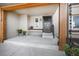 Inviting front porch with neutral-toned exterior, dark door, wooden beam supports, and potted plants at 18438 E Berry Dr, Centennial, CO 80015