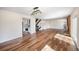 Bright, open-concept living space with wood floors, fireplace, staircase, and a view into the kitchen at 18438 E Berry Dr, Centennial, CO 80015