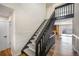 Staircase featuring modern, black railing, wood-look flooring, and plush gray carpeting at 18438 E Berry Dr, Centennial, CO 80015