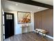 Inviting foyer featuring wood floors, contemporary decor, and an eye-catching accent wall at 1285 Roslyn St, Denver, CO 80220