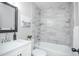 Updated bathroom with white vanity and marble-look shower/tub combo at 1716 Moline St, Aurora, CO 80010