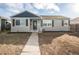 Ranch style home with gray siding, blue trim, and a well-maintained lawn at 1716 Moline St, Aurora, CO 80010