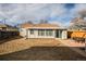 View of the house from the backyard with patio at 1716 Moline St, Aurora, CO 80010