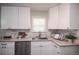 Newly remodeled kitchen featuring white shaker cabinets and granite countertops at 1716 Moline St, Aurora, CO 80010