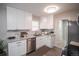 Modern white kitchen with stainless steel appliances and granite countertops at 1716 Moline St, Aurora, CO 80010