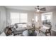 Open living room with gray sectional, armchairs, and views into the dining area at 1716 Moline St, Aurora, CO 80010