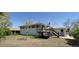 Exterior of home with deck and partially fenced backyard at 8389 Benton Way, Arvada, CO 80003