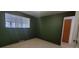 Bedroom with a window, closet, and green walls at 8389 Benton Way, Arvada, CO 80003