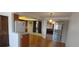 The dining area features wood floors, retro hanging light fixture, and a sliding glass door at 8389 Benton Way, Arvada, CO 80003