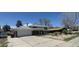 Spacious home with a large driveway and two-car garage, set against a blue sky at 8389 Benton Way, Arvada, CO 80003