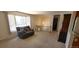 Bright living room with neutral carpet, comfortable seating, and stairs to a second floor at 8389 Benton Way, Arvada, CO 80003
