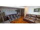 Living room with multiple sofas, an accent wall, and a sliding door to the utility area at 8389 Benton Way, Arvada, CO 80003